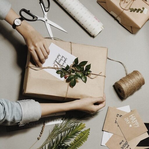 brown box beside leaves, scissors and yarn